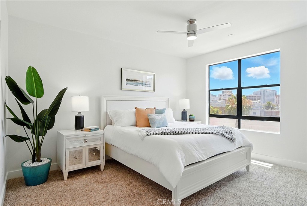 395 East 4th Street, Unit 39 Long Beach, CA 90802 - Photo 21 of 45 a bedroom with a bed a couch and a potted plant