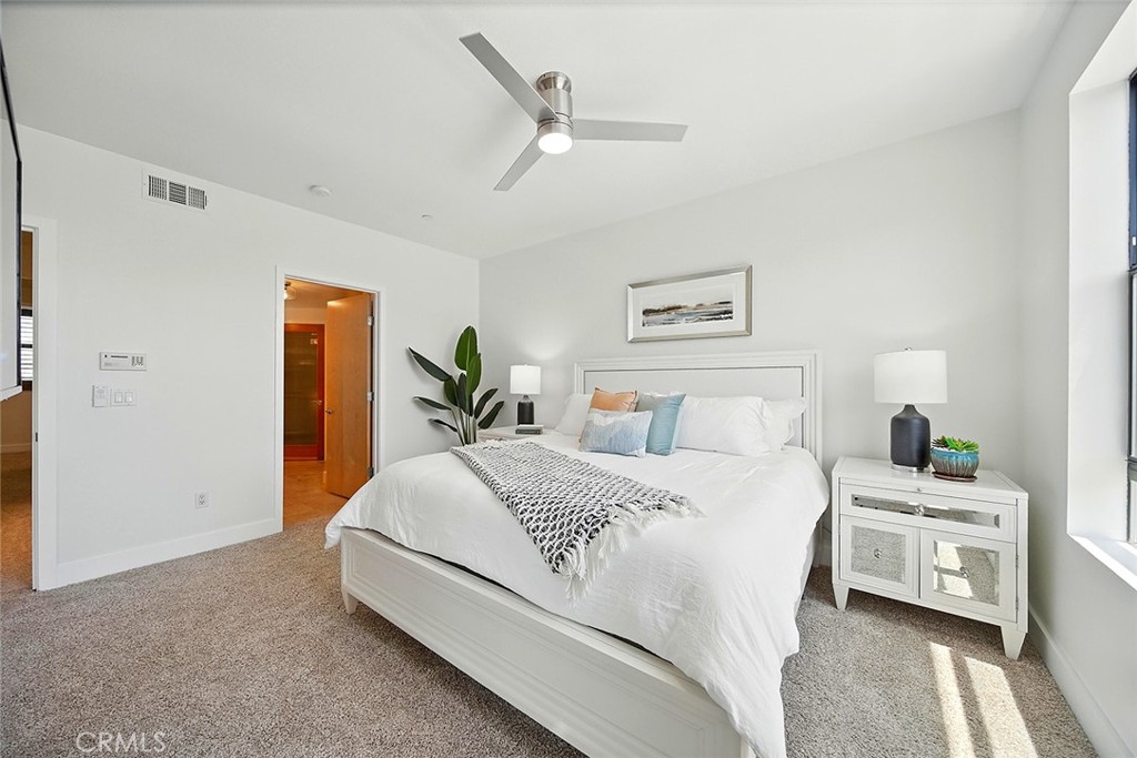 395 East 4th Street, Unit 39 Long Beach, CA 90802 - Photo 23 of 45 a spacious bedroom with a bed a window and a chandelier