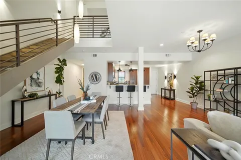 a living room with furniture chandelier and a wooden floor