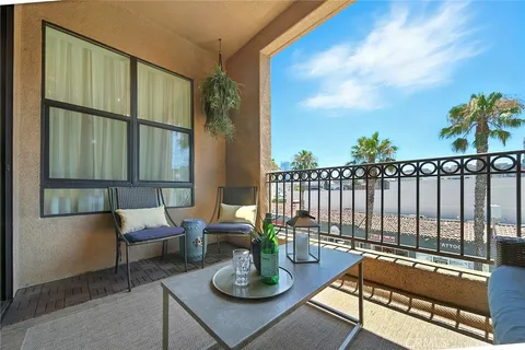 a kitchen with stainless steel appliances granite countertop a sink a stove a refrigerator cabinets and chairs