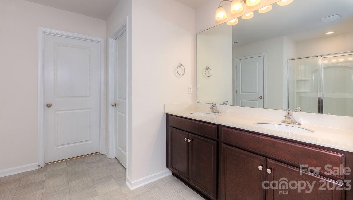 1603 Blue Velvet Lane Dallas, NC 28034 - Photo 15 of 17 a bathroom with a granite countertop sink and a mirror
