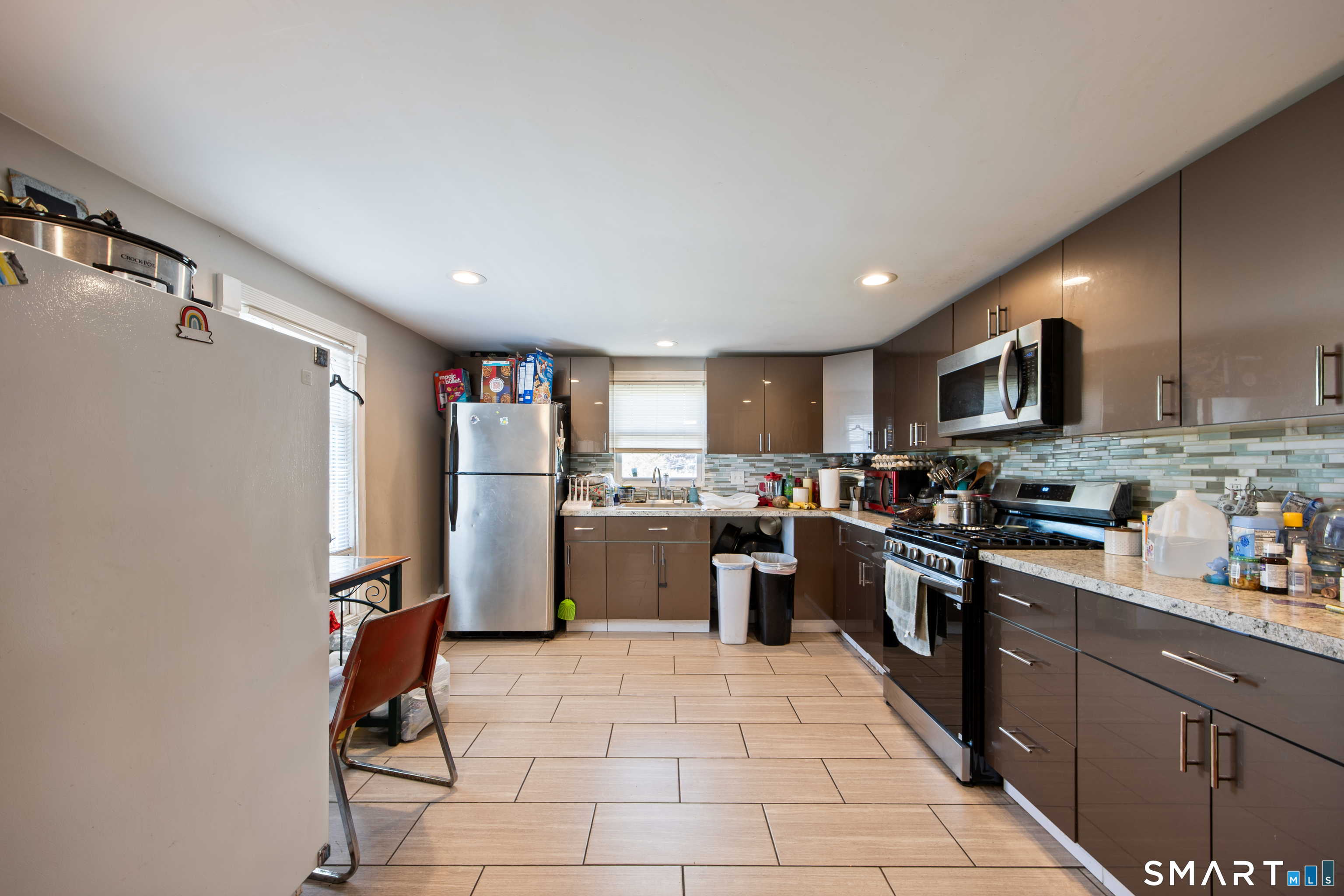 277 South Main Street Torrington, CT 06790 - Photo 18 of 26 a kitchen with stainless steel appliances granite countertop a refrigerator stove top oven and sink