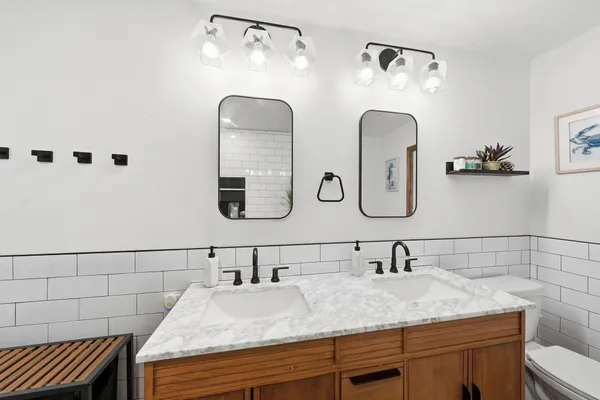 a bathroom with a granite countertop sink a mirror and vanity