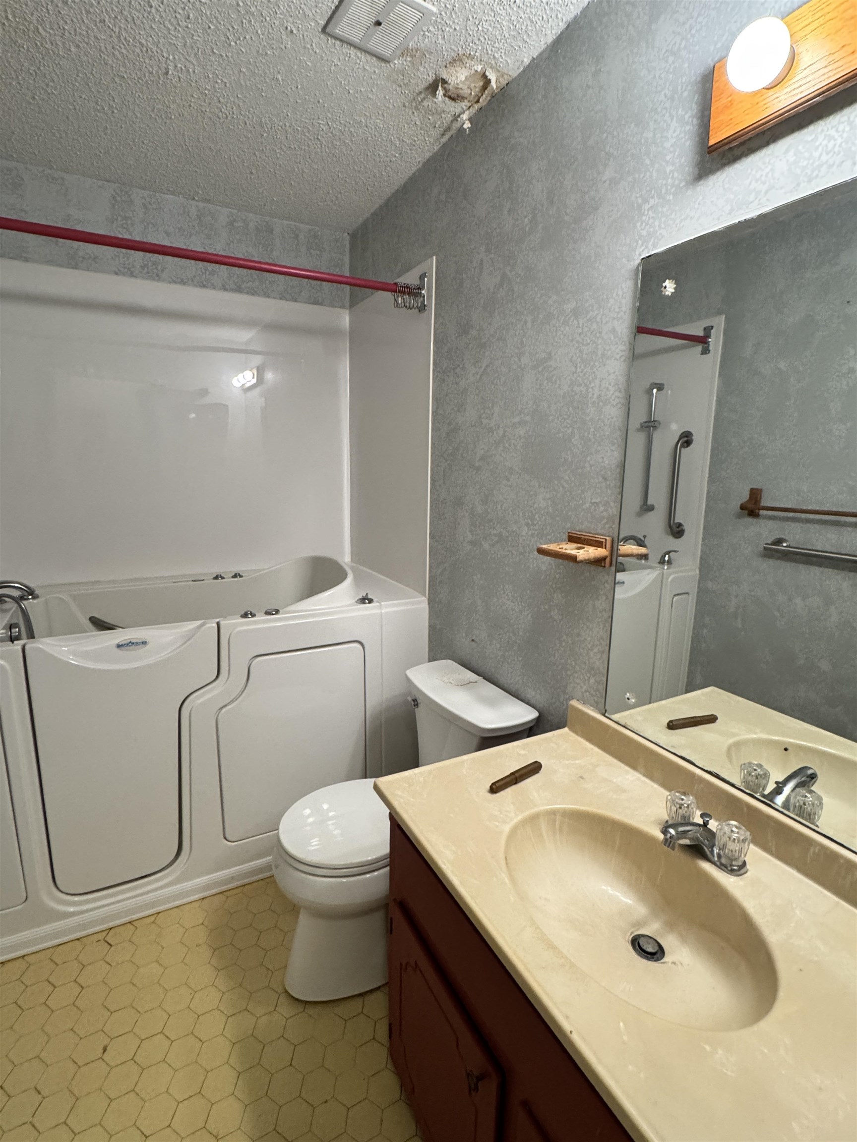 4777 Bill Knight Road Millington, TN 38053 - Photo 13 of 19 Full bath with vanity, a textured ceiling, a textured wall, and light floors