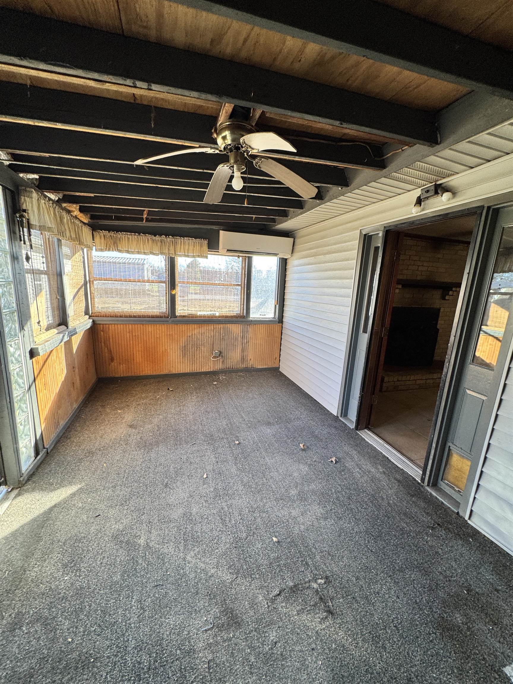 4777 Bill Knight Road Millington, TN 38053 - Photo 15 of 19 Unfurnished sunroom with a ceiling fan, carpet floors, wooden walls, and beamed ceiling