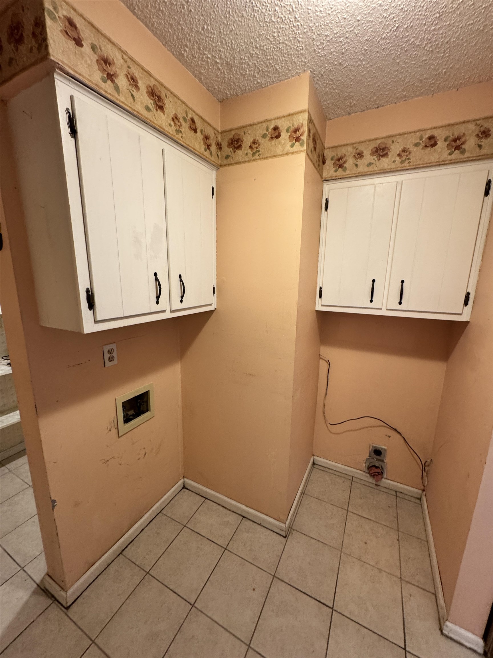 4777 Bill Knight Road Millington, TN 38053 - Photo 16 of 19 Laundry room featuring cabinet space, hookup for a washing machine, a textured ceiling, and light tile patterned floors