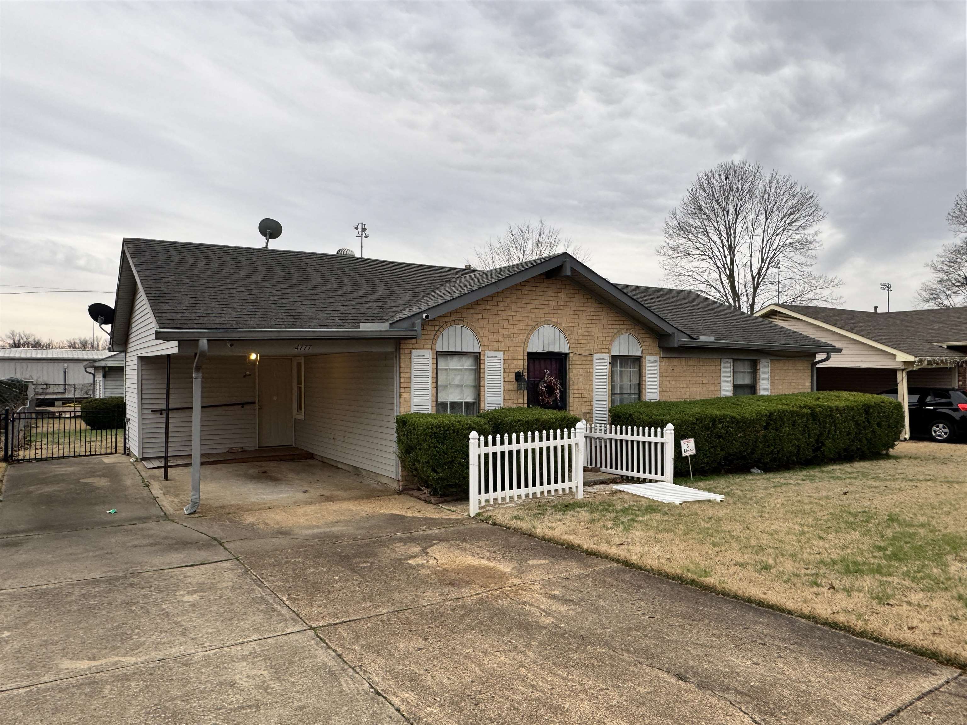 4777 Bill Knight Road Millington, TN 38053 - Photo 3 of 19 Ranch-style house with driveway, a shingled roof, a carport, and brick siding