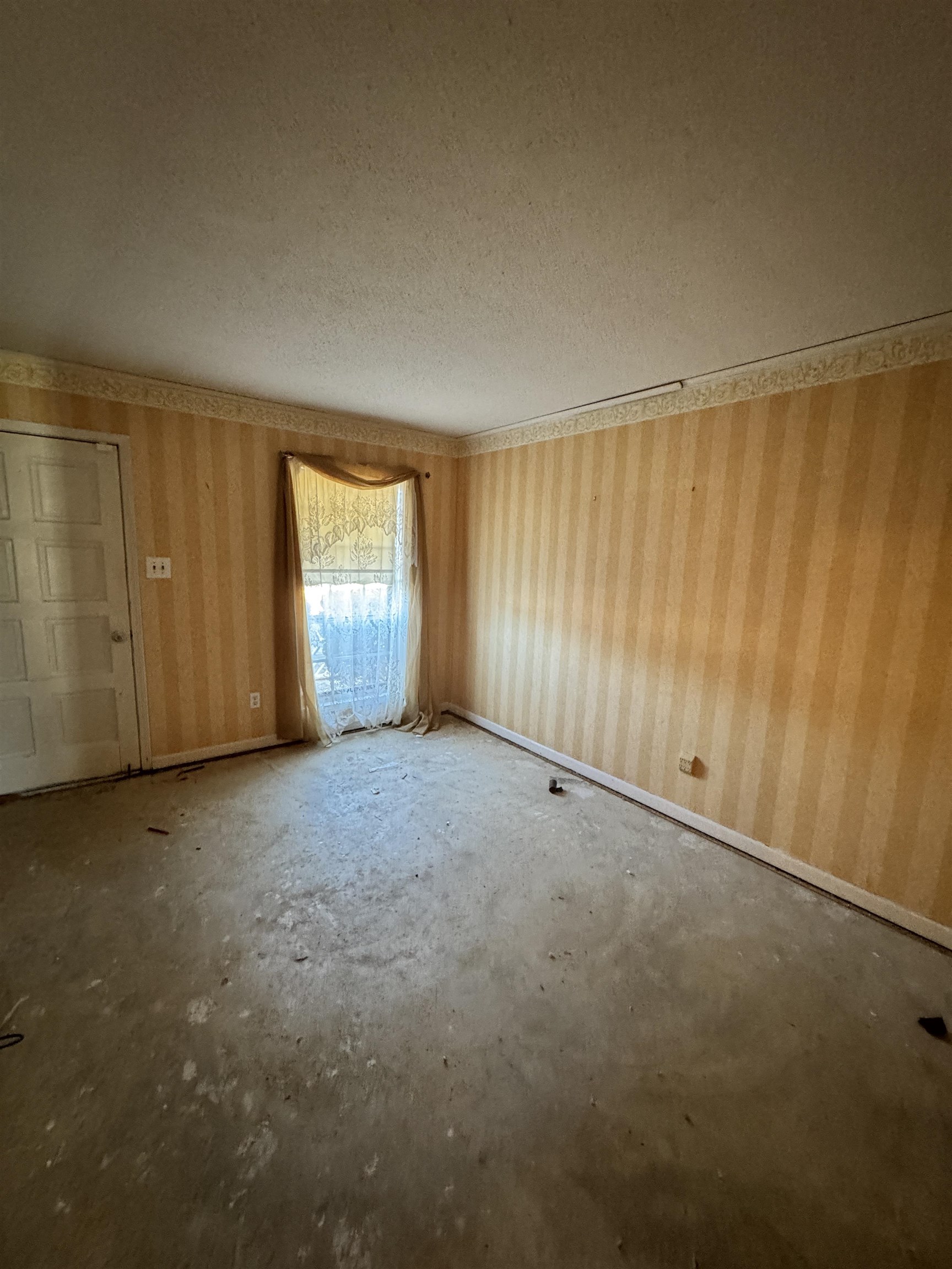 4777 Bill Knight Road Millington, TN 38053 - Photo 4 of 19 Empty room featuring a textured ceiling and wallpapered walls