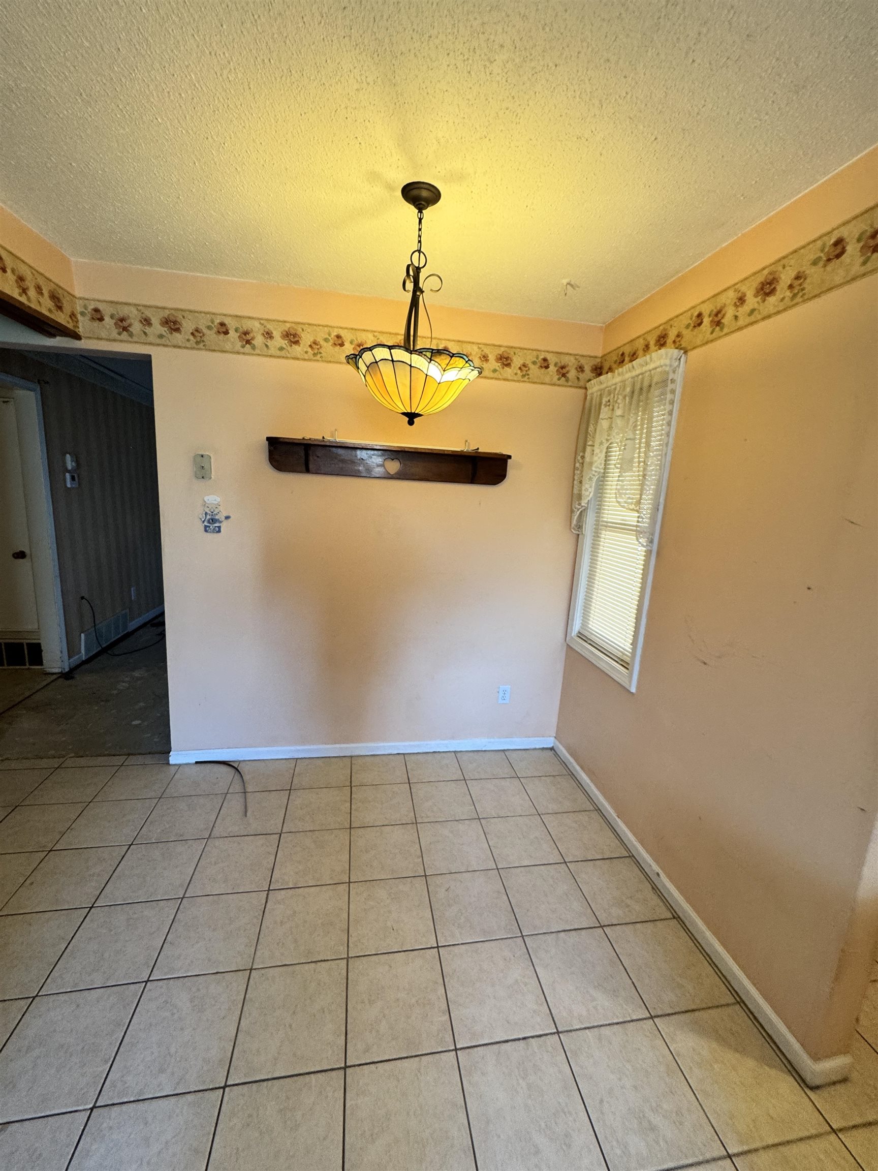 4777 Bill Knight Road Millington, TN 38053 - Photo 5 of 19 Unfurnished dining area featuring a textured ceiling and light tile patterned floors