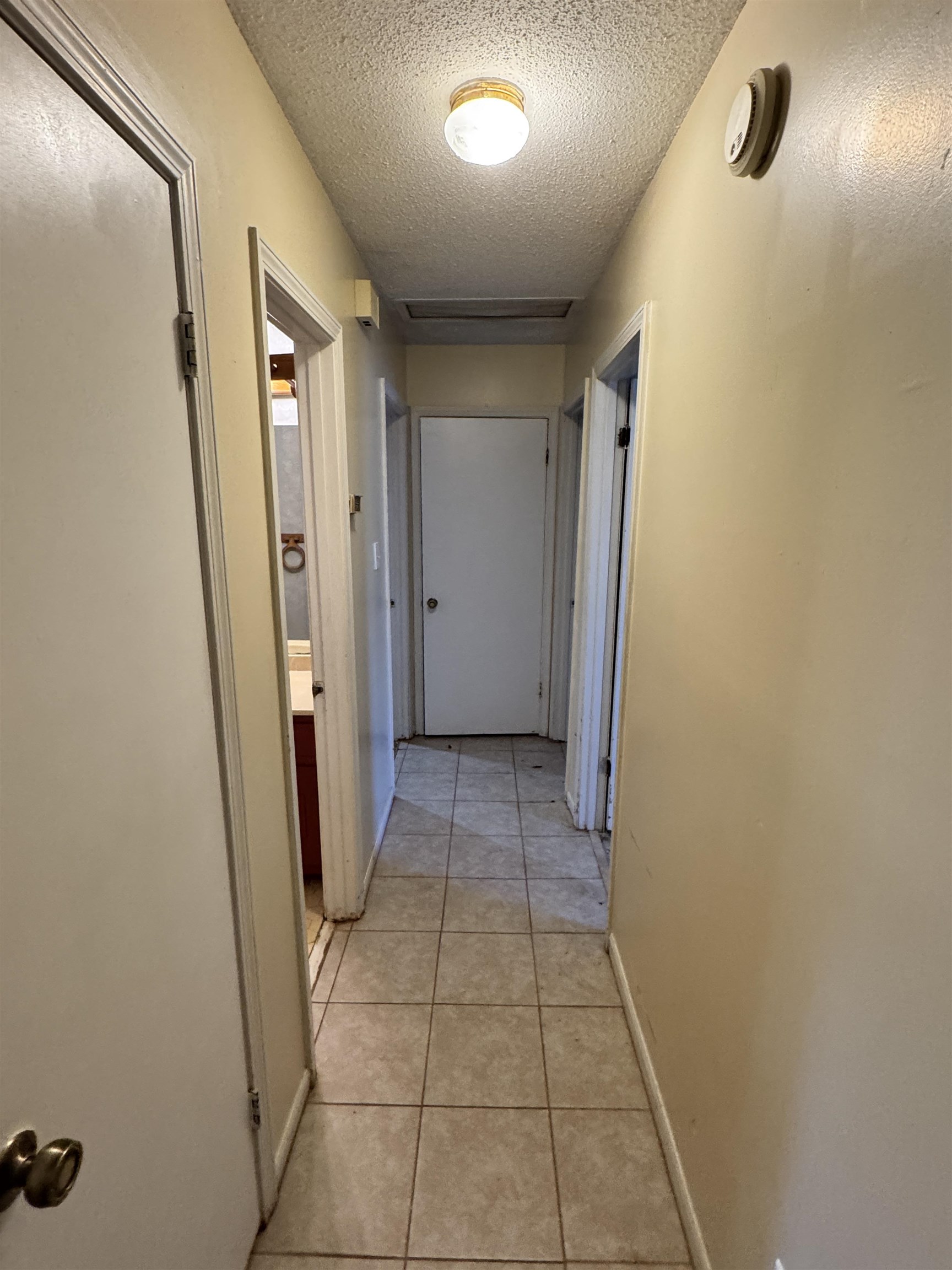 4777 Bill Knight Road Millington, TN 38053 - Photo 9 of 19 Corridor with a textured ceiling and light tile patterned flooring