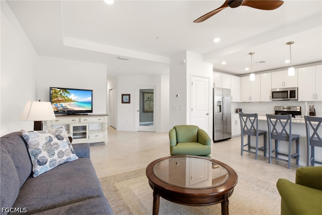 3751 Pebblebrook Ridge Court, Unit 101 Fort Myers, FL 33905 - Photo 14 of 48 a living room with furniture and a flat screen tv