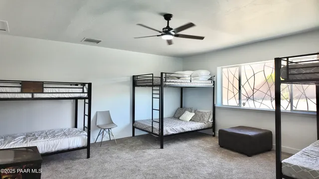 a bedroom with a bed and a ceiling fan
