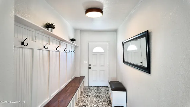 a view of a hallway with wooden floor and entryway