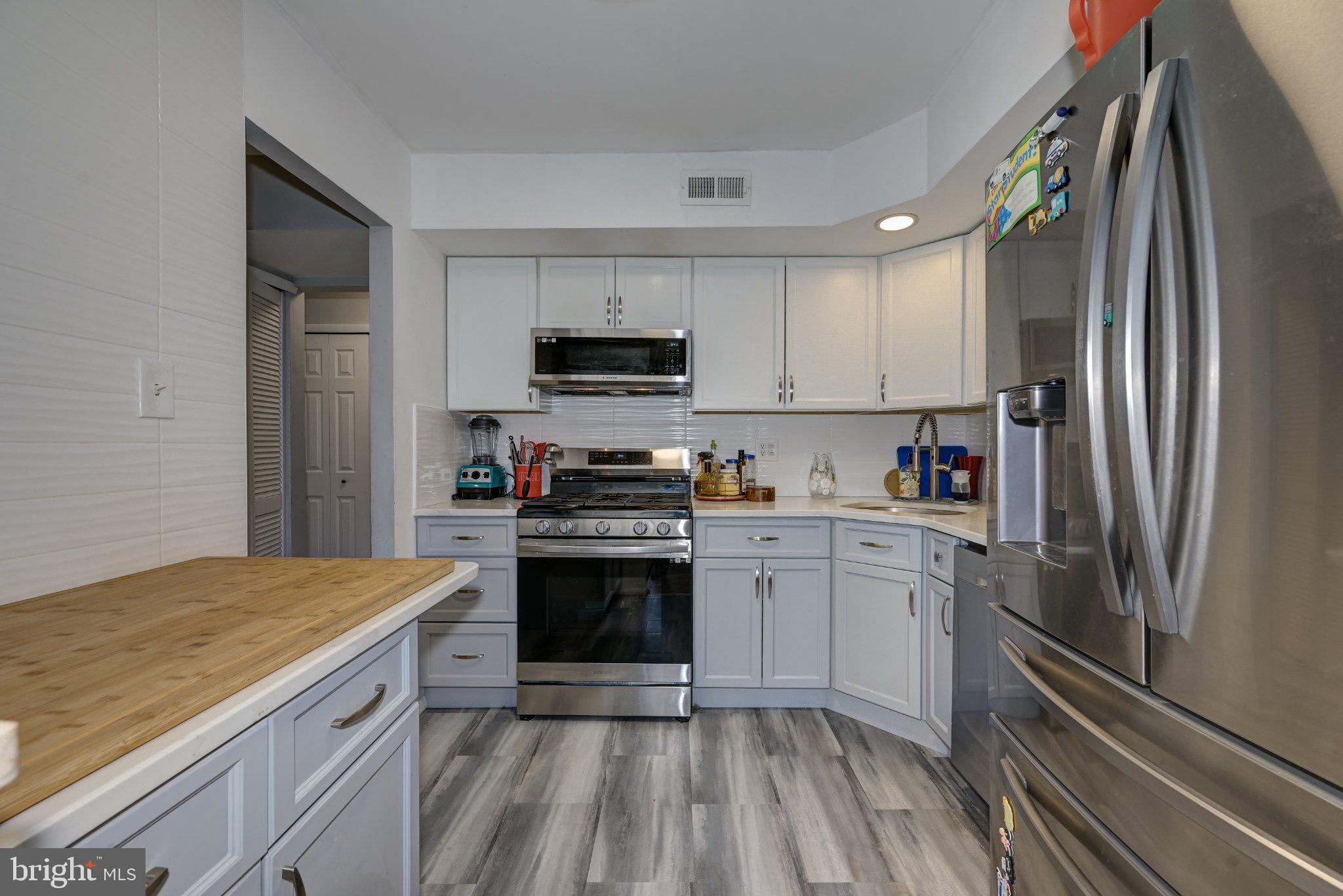 75 Sandra Road Voorhees, NJ 08043 - Photo 12 of 25 a kitchen with a sink stove and refrigerator