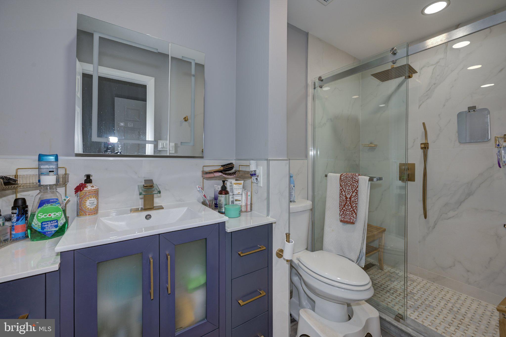 75 Sandra Road Voorhees, NJ 08043 - Photo 17 of 25 a bathroom with a sink toilet vanity and shower