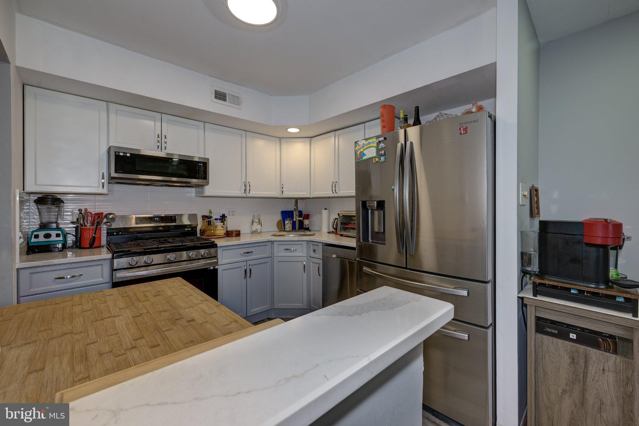 75 Sandra Road Voorhees, NJ 08043 - Photo 10 of 25 a kitchen with a refrigerator and a stove top oven