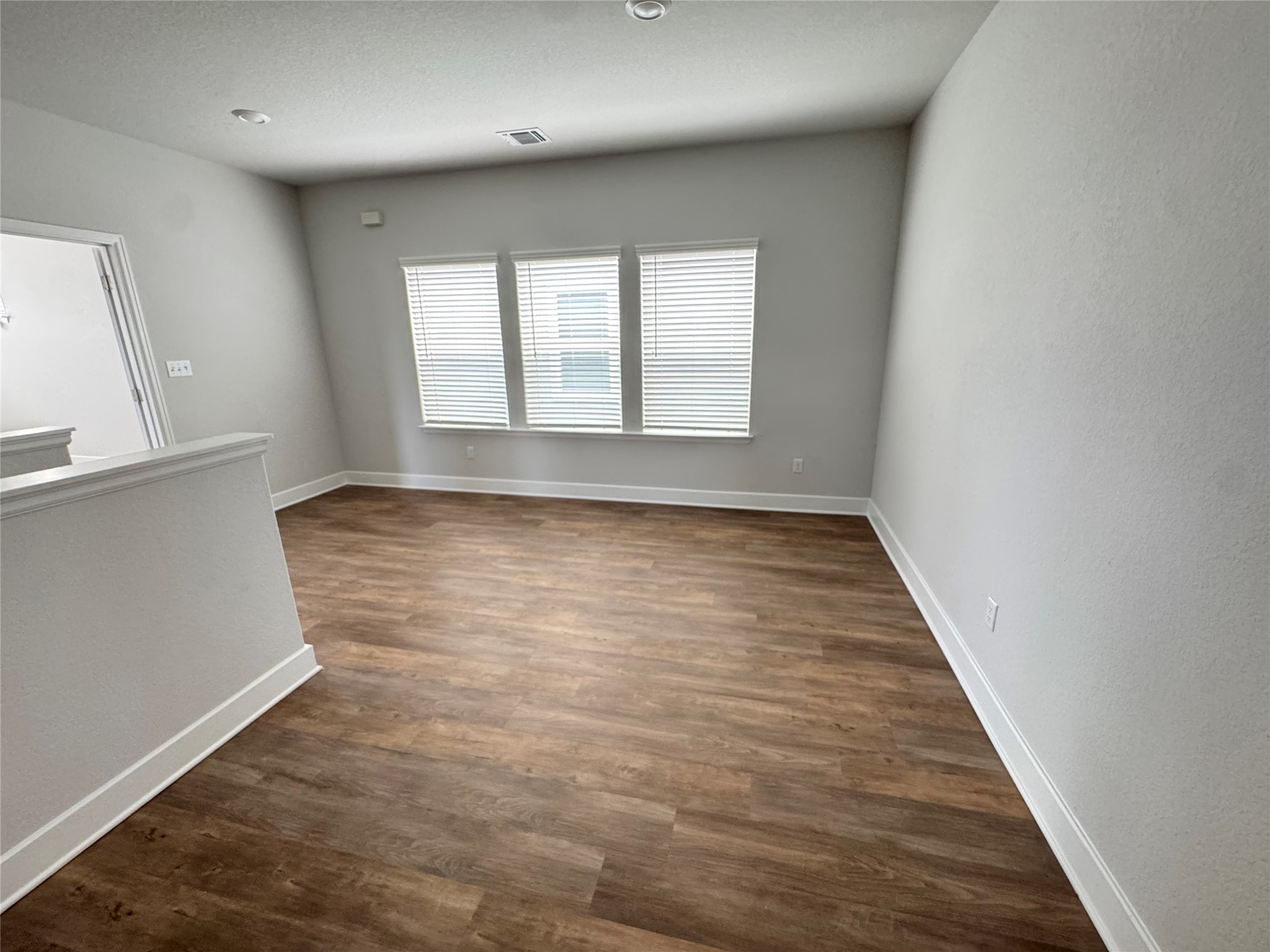 3000 Chisholm Trail Road, Unit 33 Round Rock, TX 78681 - Photo 11 of 31 wooden floor in an empty room with a window
