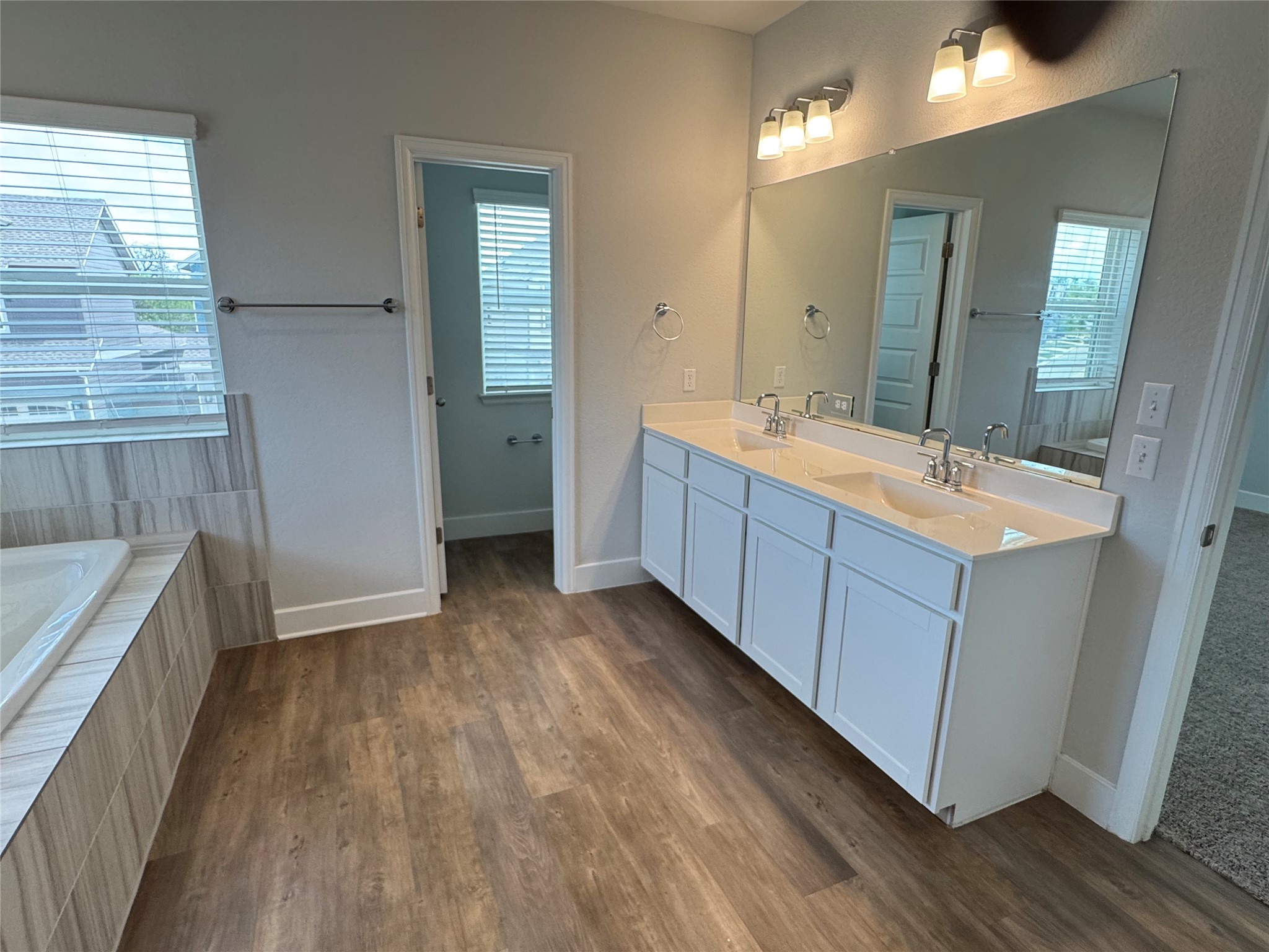 3000 Chisholm Trail Road, Unit 33 Round Rock, TX 78681 - Photo 14 of 31 a bathroom with a tub sink and mirror