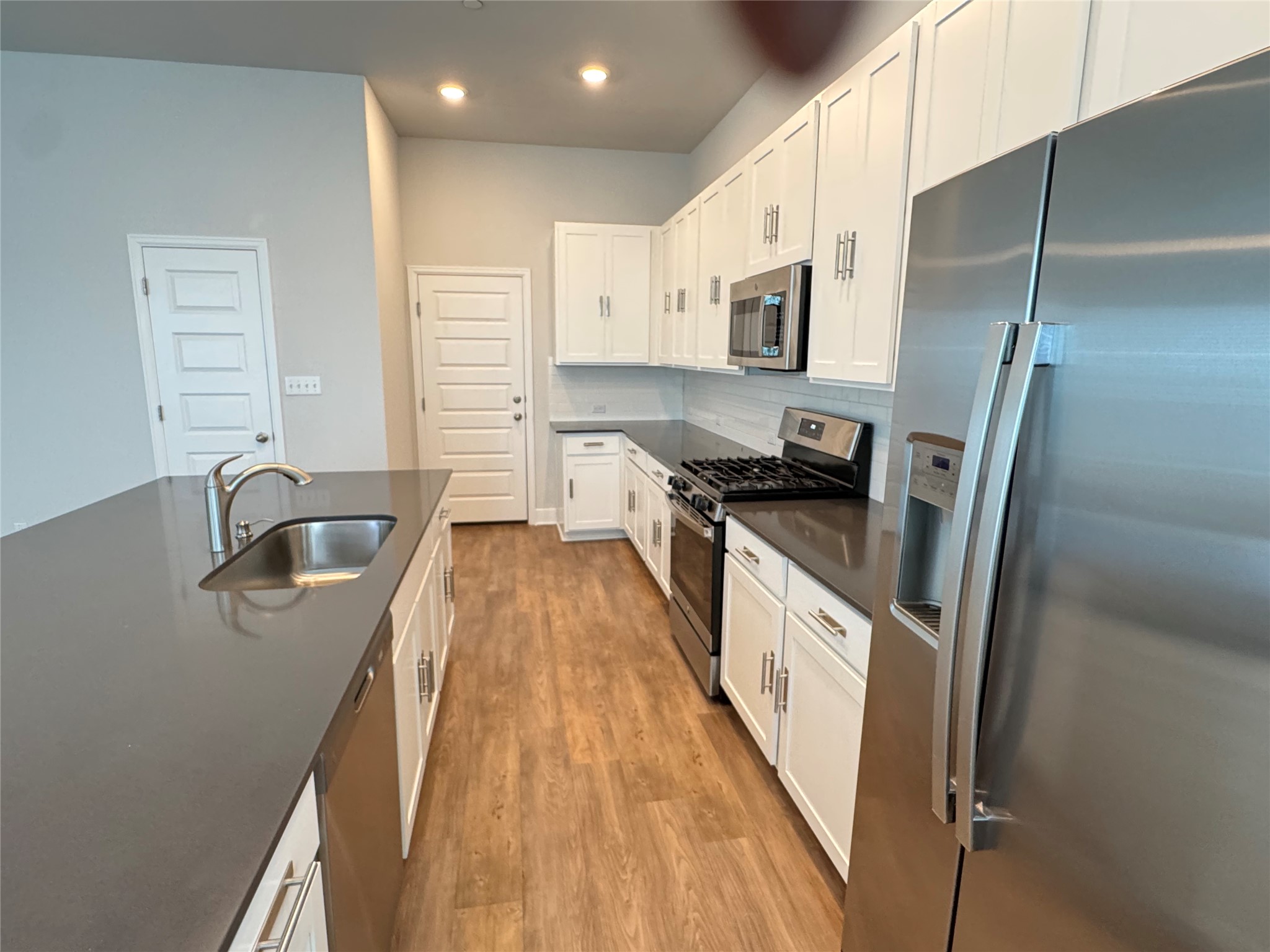 3000 Chisholm Trail Road, Unit 33 Round Rock, TX 78681 - Photo 4 of 31 a kitchen with stainless steel appliances granite countertop a sink stove and refrigerator