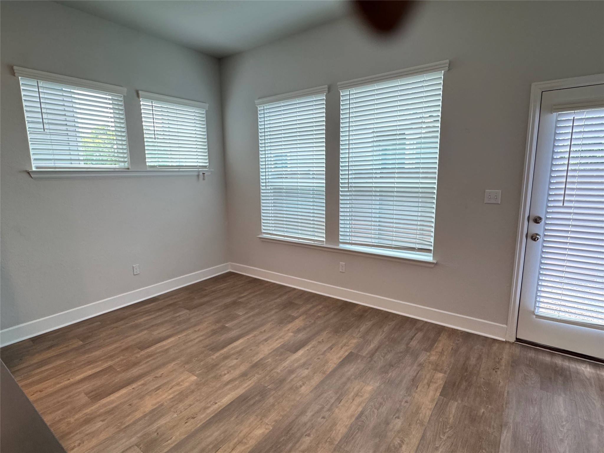 3000 Chisholm Trail Road, Unit 33 Round Rock, TX 78681 - Photo 7 of 31 an empty room with wooden floor and windows
