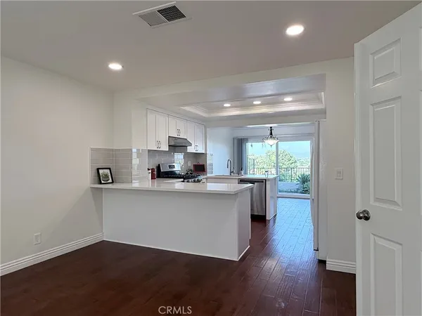 a view of a backyard with swimming pool and furniture