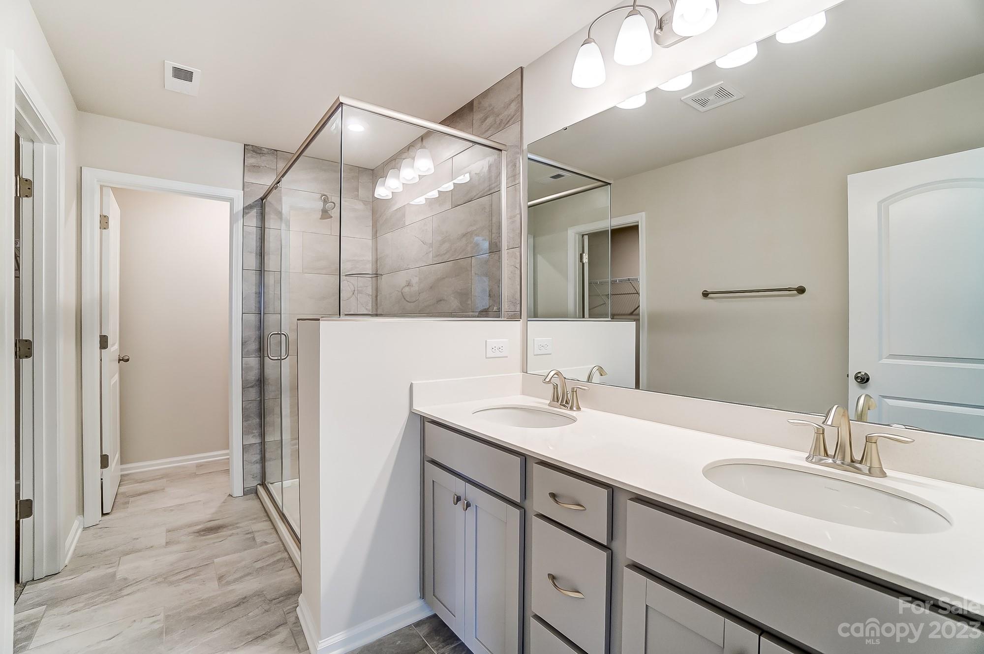15317 Braid Mdw Drive, Unit 170 Charlotte, NC 28278 - Photo 11 of 29 a bathroom with a sink double vanity and a mirror