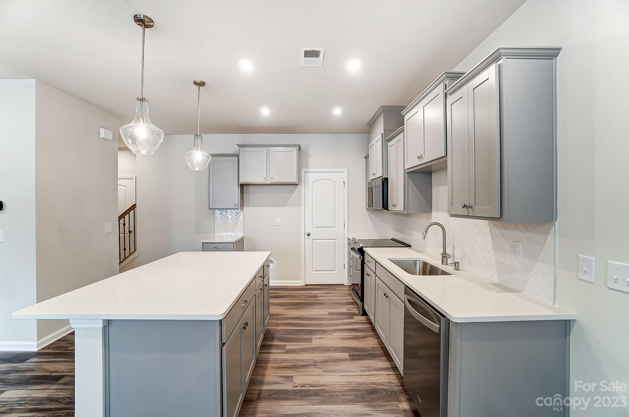 15317 Braid Mdw Drive, Unit 170 Charlotte, NC 28278 - Photo 13 of 29 a kitchen with stainless steel appliances a sink stove and refrigerator