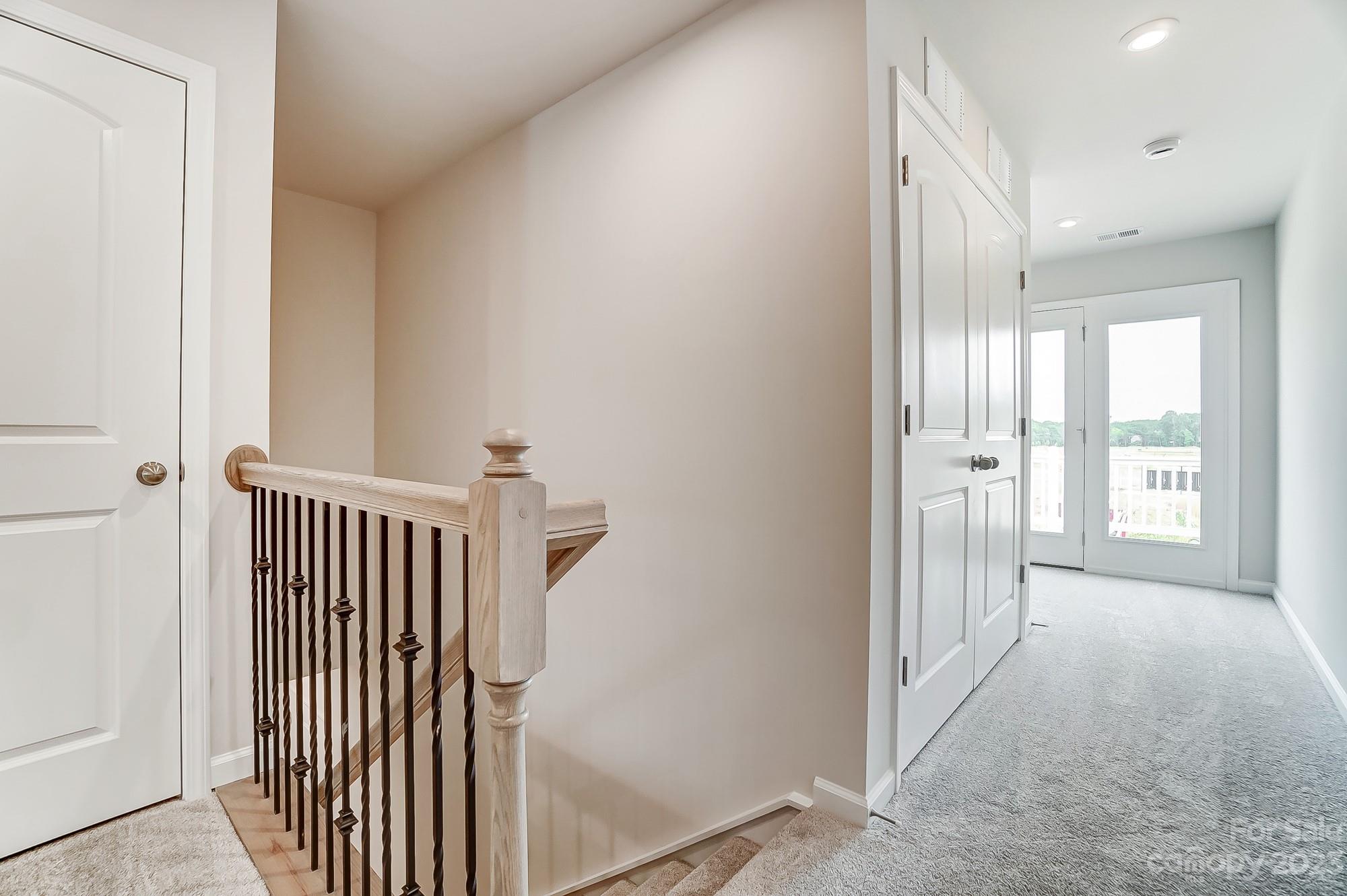 15317 Braid Mdw Drive, Unit 170 Charlotte, NC 28278 - Photo 19 of 29 a view of a hallway with wooden floor and staircase