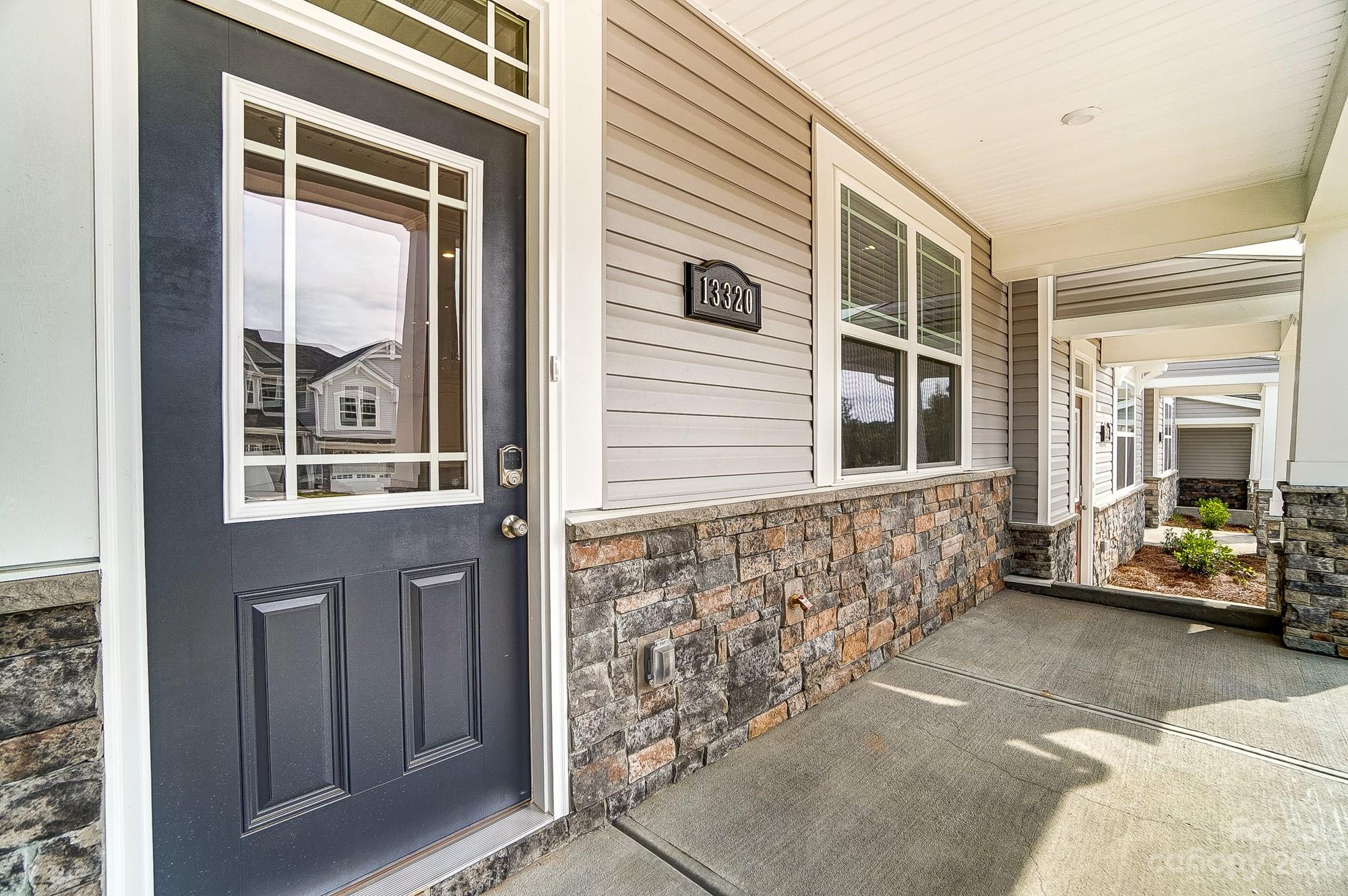 15317 Braid Mdw Drive, Unit 170 Charlotte, NC 28278 - Photo 2 of 29 a front view of a house with glass windows