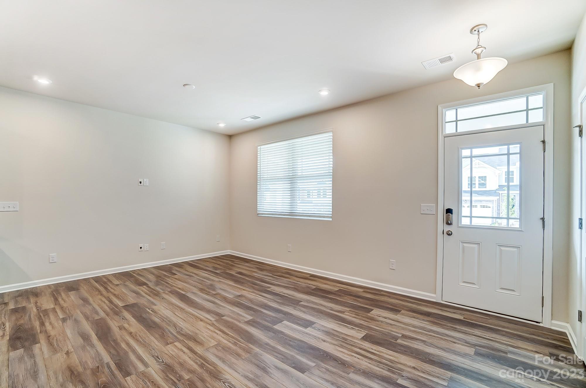 15317 Braid Mdw Drive, Unit 170 Charlotte, NC 28278 - Photo 22 of 29 a view of empty room with wooden floor and fan