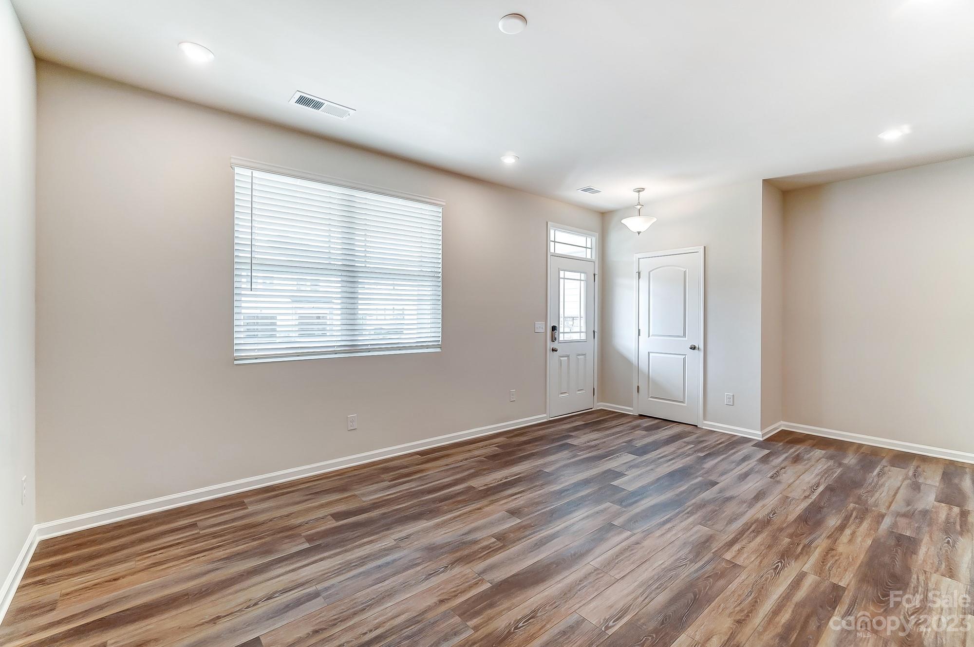 15317 Braid Mdw Drive, Unit 170 Charlotte, NC 28278 - Photo 24 of 29 a view of an empty room with wooden floor and a window