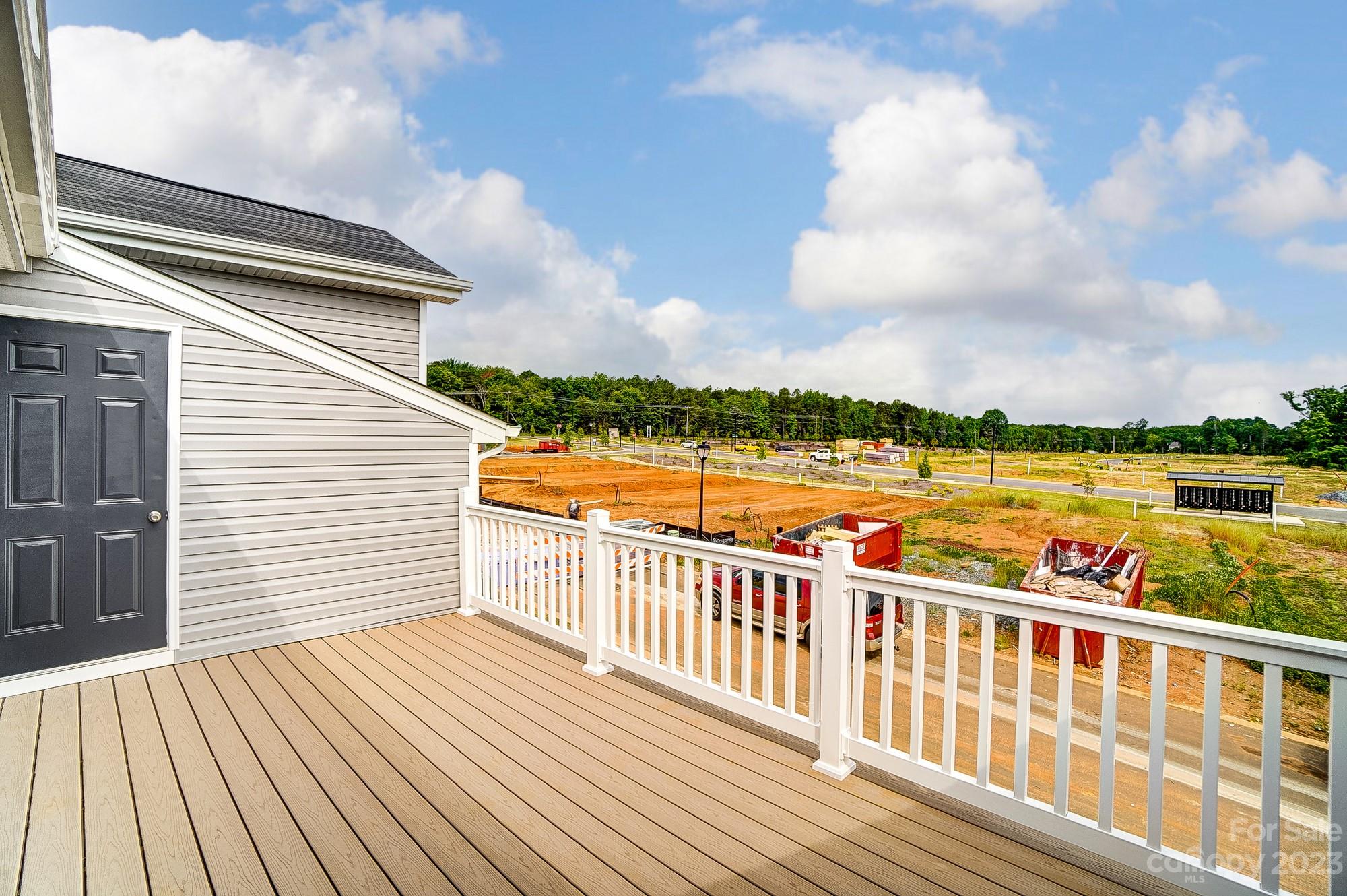 15317 Braid Mdw Drive, Unit 170 Charlotte, NC 28278 - Photo 3 of 29 a view of a balcony with wooden floor & fence