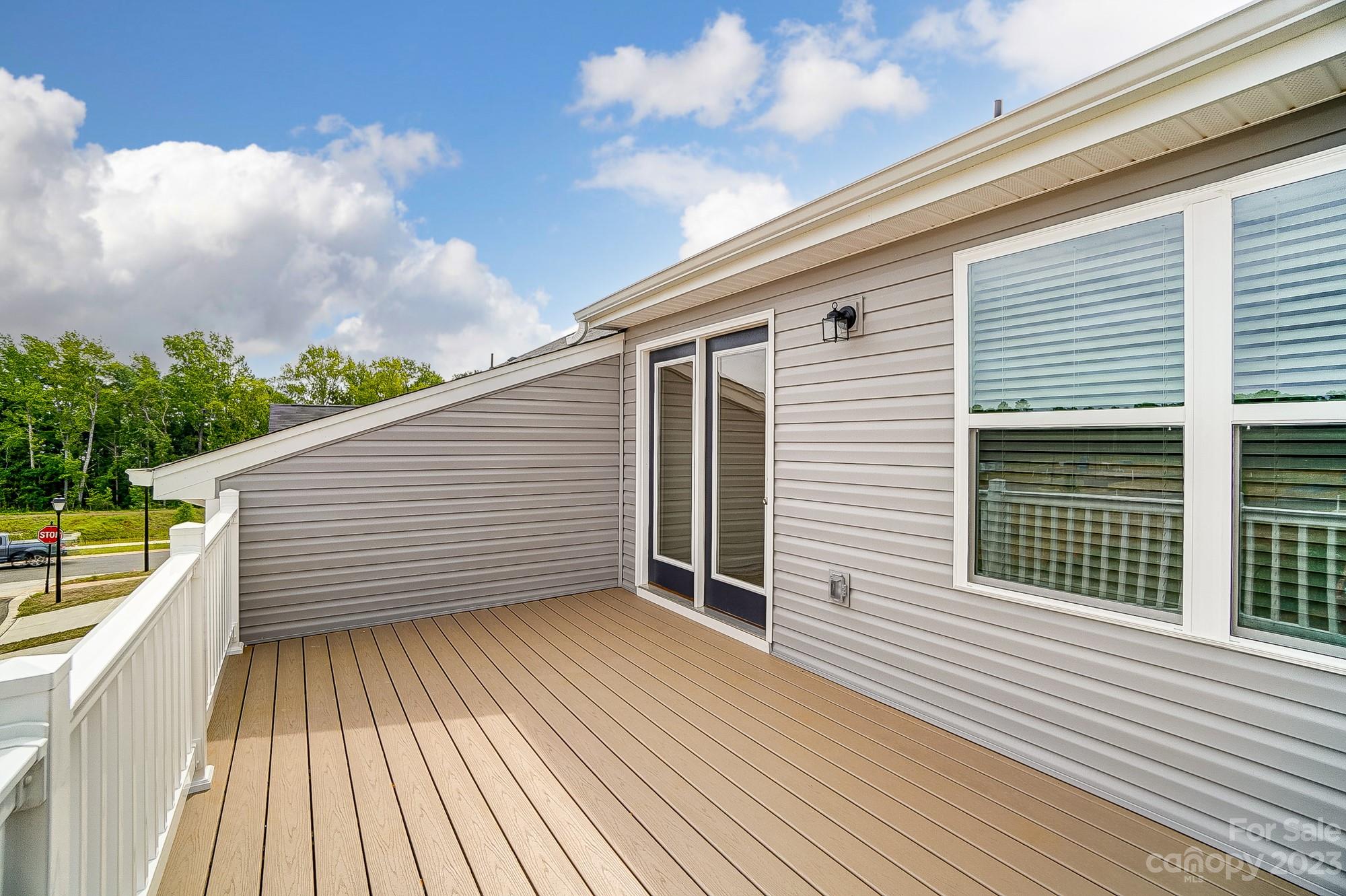 15317 Braid Mdw Drive, Unit 170 Charlotte, NC 28278 - Photo 4 of 29 a view of a balcony with wooden floor and fence