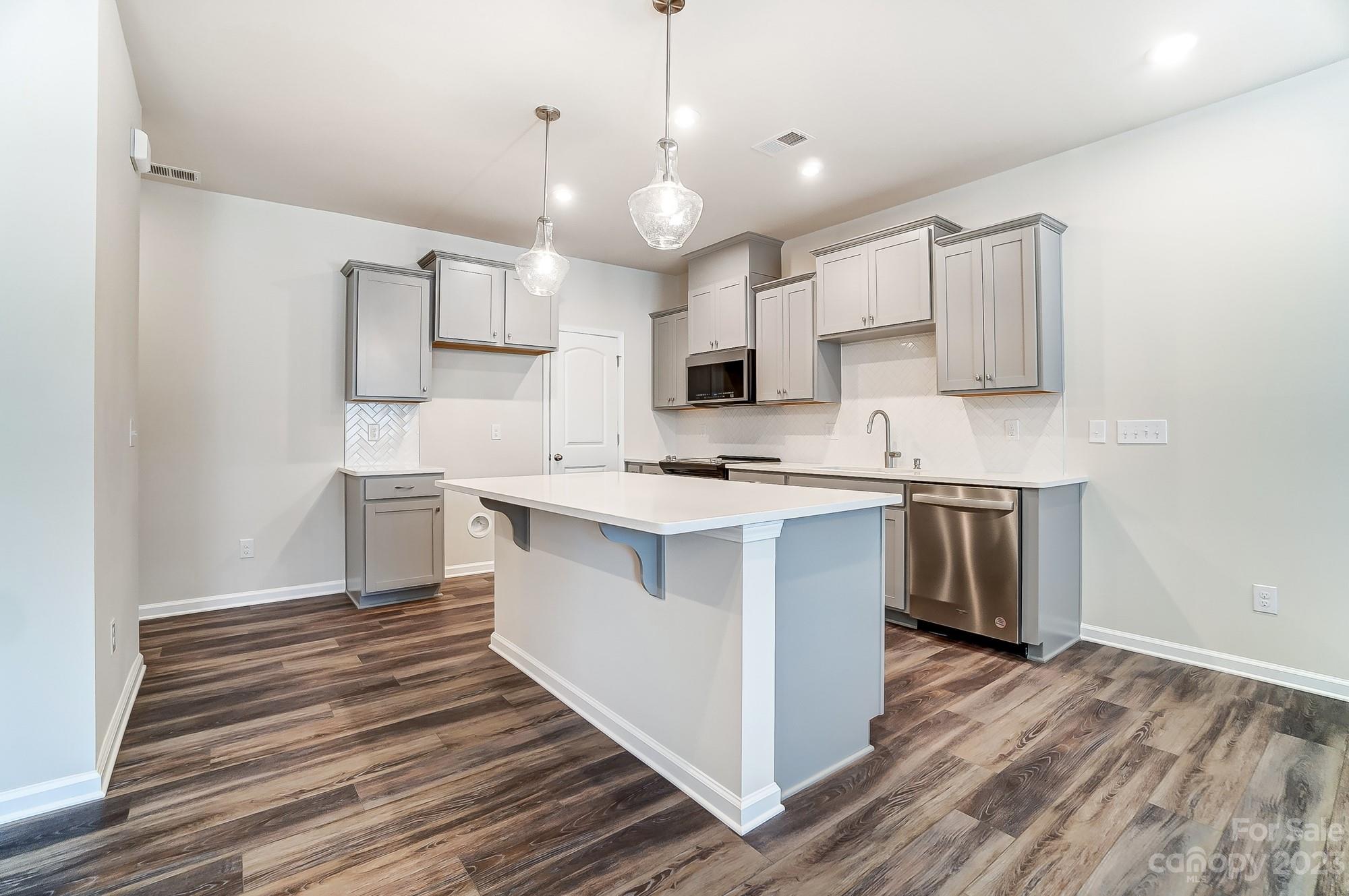 15317 Braid Mdw Drive, Unit 170 Charlotte, NC 28278 - Photo 6 of 29 a kitchen with cabinets wooden floor and a sink