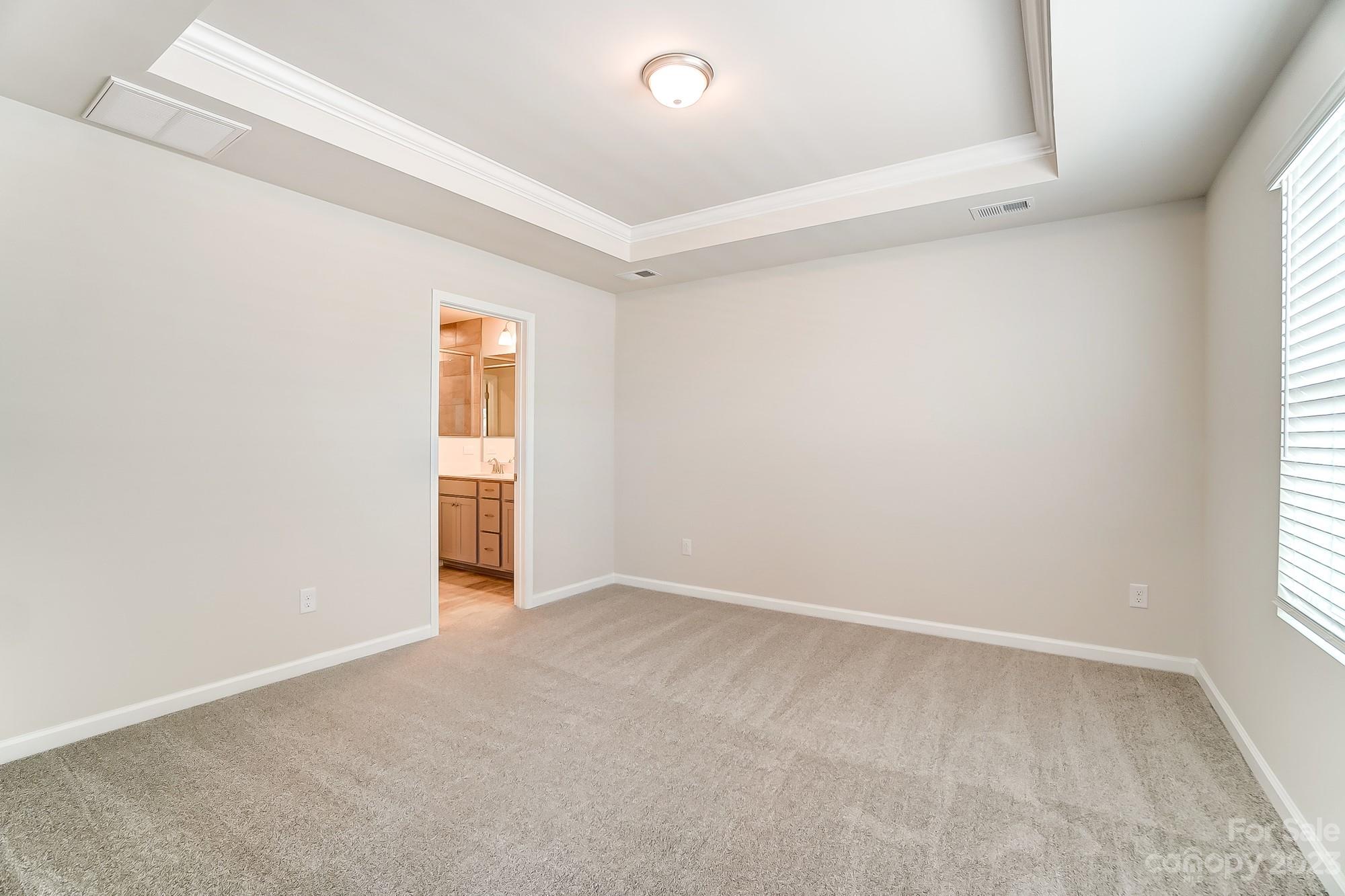15317 Braid Mdw Drive, Unit 170 Charlotte, NC 28278 - Photo 7 of 29 an empty room with a window and wooden floor