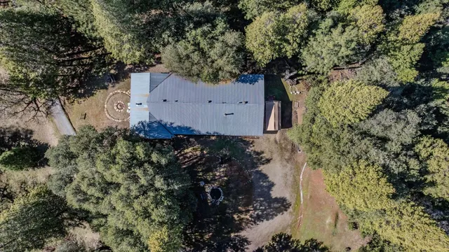 an aerial view of a house with a yard