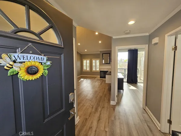 a view of a hallway with wooden floor