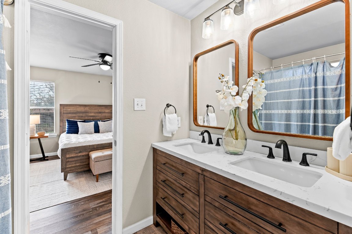 2201 Whistling Way Taylor, TX 76574 - Photo 31 of 40 a en suite bathroom with a double vanity sink and a mirror
