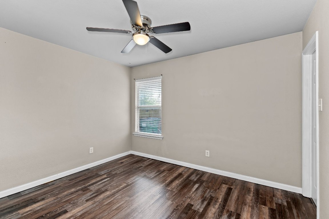 2201 Whistling Way Taylor, TX 76574 - Photo 7 of 40 an empty room with wooden floor fan and windows