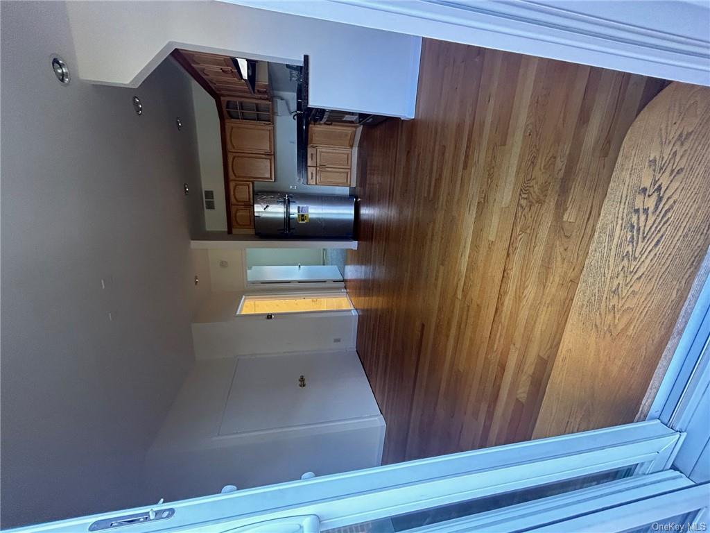 25 South Division Street Peekskill, NY 10566 - Photo 11 of 20 Kitchen with dark hardwood / wood-style flooring, range hood, and refrigerator