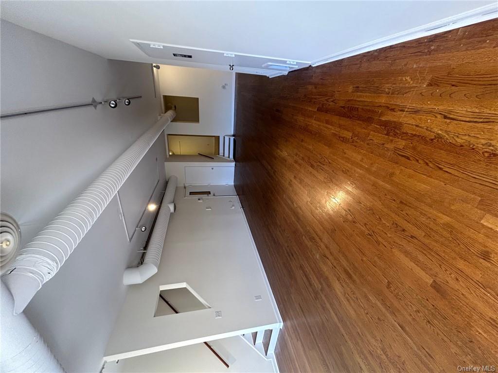 25 South Division Street Peekskill, NY 10566 - Photo 2 of 20 Unfurnished living room with track lighting and dark wood-type flooring