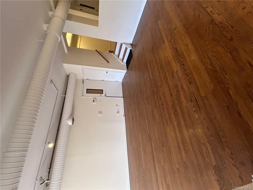 25 South Division Street Peekskill, NY 10566 - Photo 3 of 20 Unfurnished room featuring dark wood-type flooring