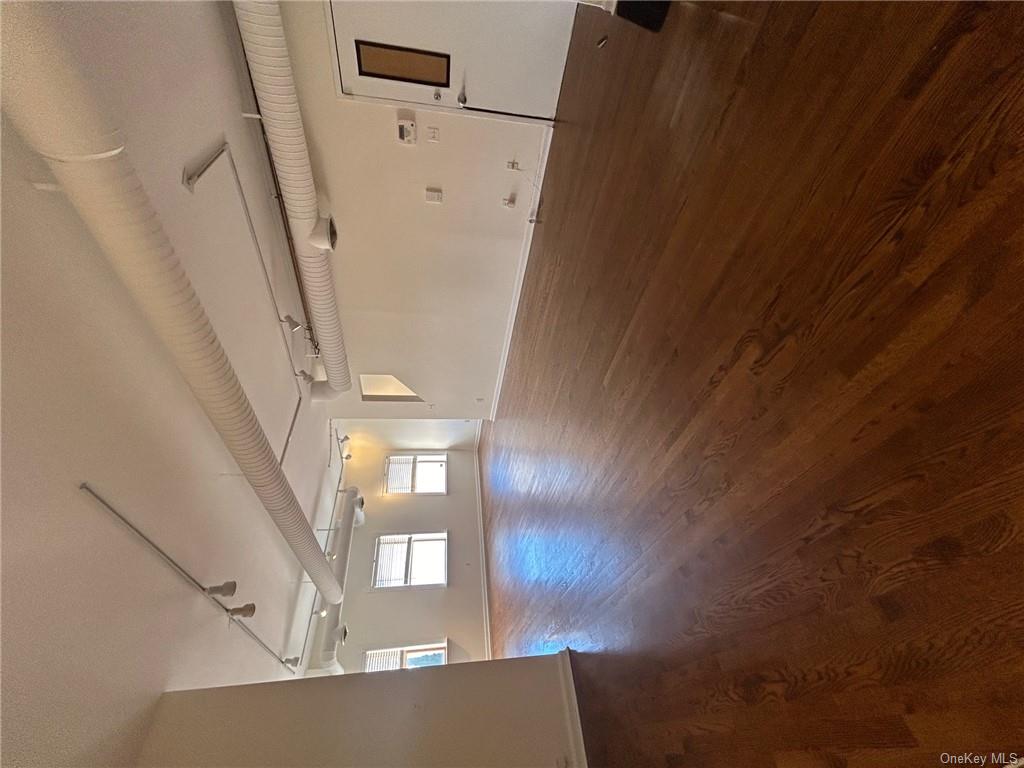 25 South Division Street Peekskill, NY 10566 - Photo 4 of 20 Spare room with dark wood-type flooring and rail lighting