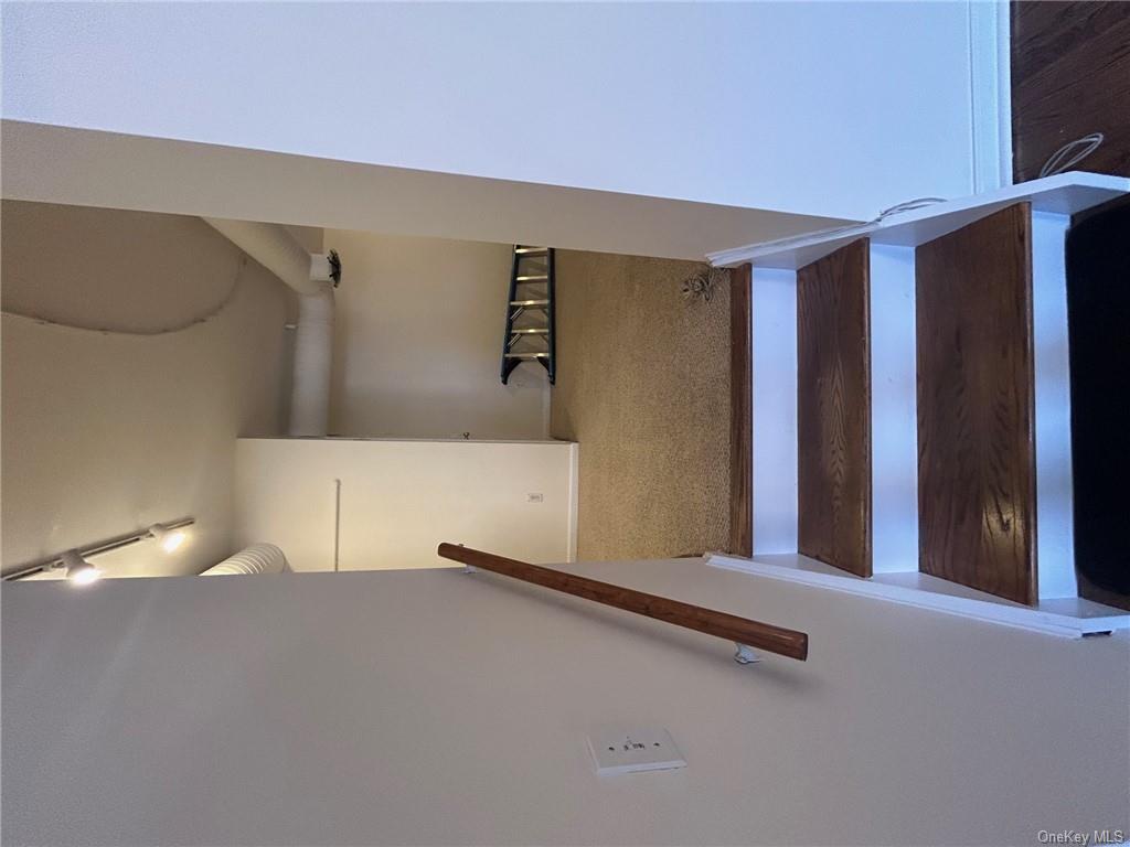25 South Division Street Peekskill, NY 10566 - Photo 6 of 20 Stairway featuring hardwood / wood-style floors and track lighting