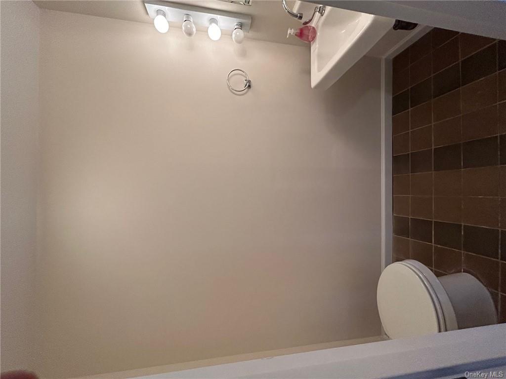 25 South Division Street Peekskill, NY 10566 - Photo 8 of 20 Bathroom with toilet, sink, and tile in showroom