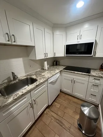 a kitchen with a sink and cabinets