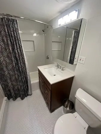 a bathroom with a sink vanity mirror and toilet