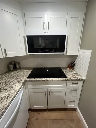 a stove top oven sitting inside of a kitchen