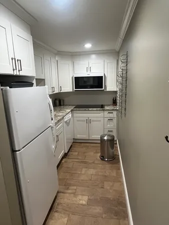 a kitchen with a sink appliances and cabinets