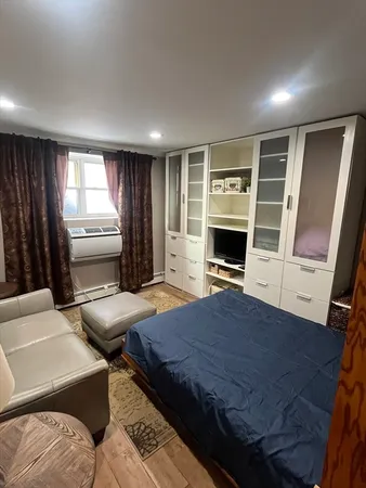a bedroom with a bed and a television